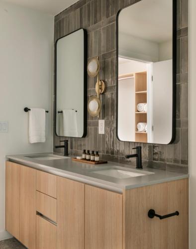 a bathroom with a sink and a mirror at ROOST Rainey in Austin