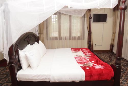 Vuode tai vuoteita majoituspaikassa Cosmil Executive Suites Najjanankumbi Kampala