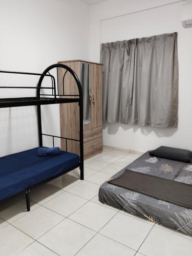 a room with two bunk beds and a window at IJM Suria Homestay in Sandakan