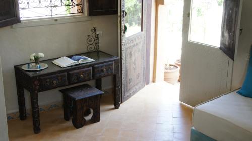 a room with a desk with a book on it at Riad Jardin des Orangers in Taroudant