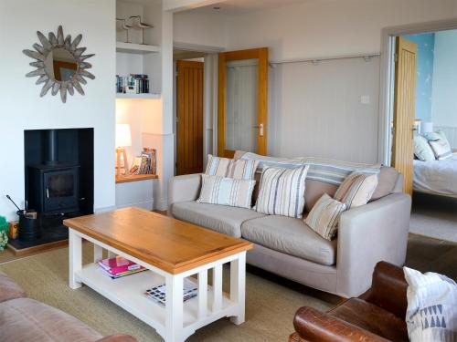 a living room with a couch and a table at Gullsway in Beadnell