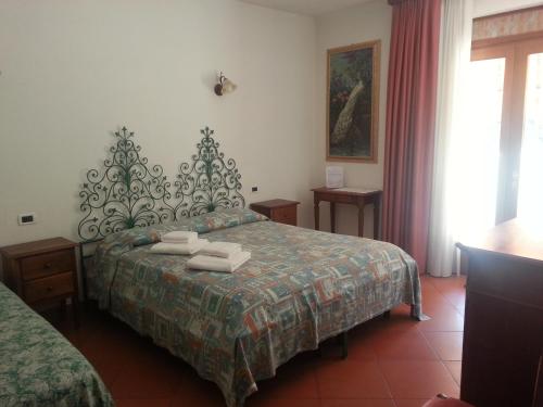 Posteľ alebo postele v izbe v ubytovaní Agriturismo Corte Trincerone