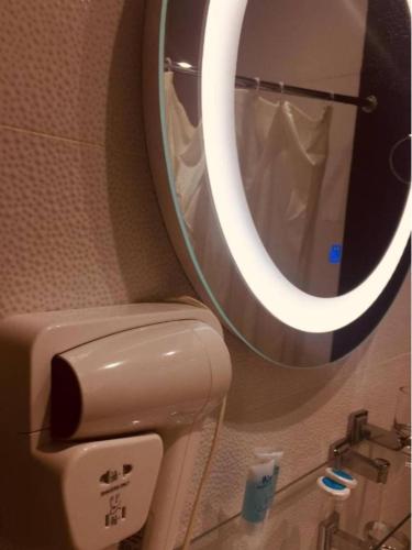 a bathroom with a toilet and a mirror at Hotel New Royal in Tbilisi City