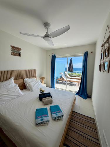a bedroom with a bed with a view of the beach at Villa Ar Mor - Oceanfront pool & Saint-Barth view Oyster pond in Saint Martin