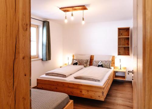 a bedroom with two beds and a window at Bauernhofurlaub Eggcellence in Teisendorf