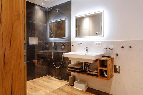 a bathroom with a sink and a shower at Bauernhofurlaub Eggcellence in Teisendorf