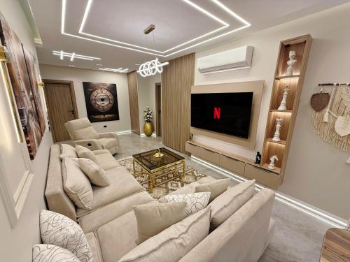 a living room with a couch and a tv at Arabella Residence 3BR - New Cairo Luxury Serviced Apartments in Cairo