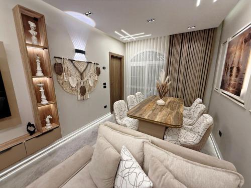 a living room with a couch and a table and chairs at Arabella Residence 3BR - New Cairo Luxury Serviced Apartments in Cairo