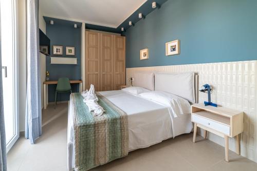 a bedroom with a bed with a white cat on a table at Penelope al mare 6 in Alba Adriatica