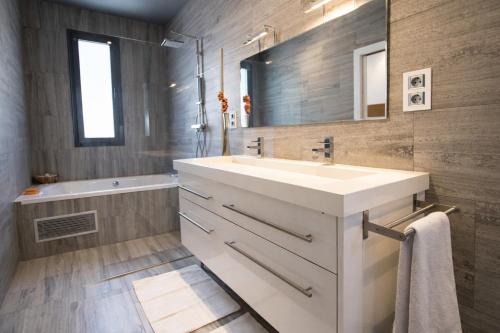 a bathroom with a white sink and a mirror at Catalunya Casas Modern Marvel,15 min to Costa Brava beaches! in Sils