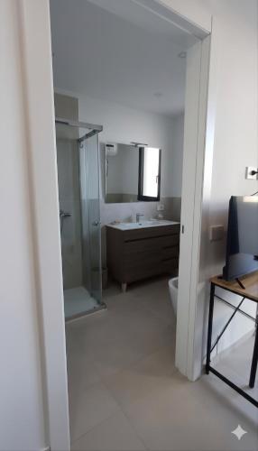 a bathroom with a shower and a sink and a toilet at Oris in Oristano