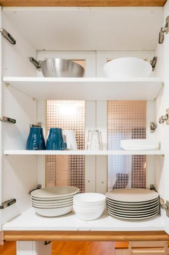 a kitchen with plates and dishes on shelves at Adrimarcangas 2 in Cangas de Onís
