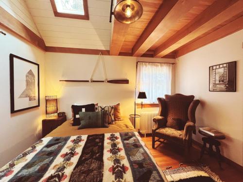 a bedroom with a king sized bed and a chair at Campo Carnelian in Carnelian Bay