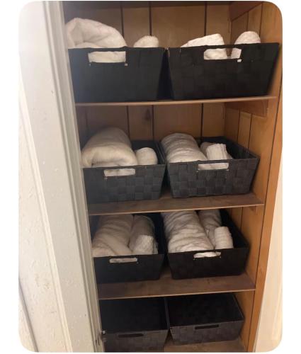 a closet filled with boxes and white towels at Heavenly Home in Monroe