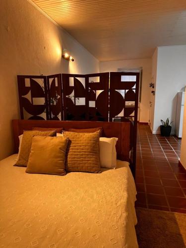 a bedroom with a bed with yellow sheets and pillows at Casa do Alto da Torre in Abrantes