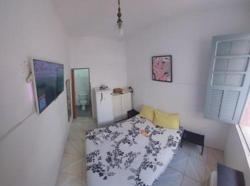 a bedroom with a bed with a black and white blanket at Rio Private Budget Suite & Easy Transport Access in Rio de Janeiro