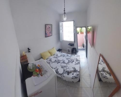 a living room with a bed and a table at Rio Private Budget Suite & Easy Transport Access in Rio de Janeiro