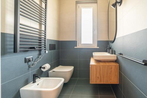 a bathroom with a sink and a toilet and a mirror at Penelope al mare 20 in Alba Adriatica