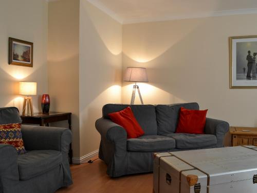a living room with a couch and two chairs at Ness-Side Apartment in Inverness