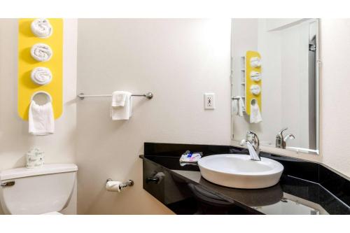 a bathroom with a sink and a toilet and a mirror at Motel 6 Augusta GA Fort Gordon in Augusta
