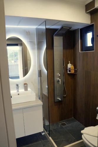 a bathroom with a shower and a sink at SABBAL apartments in Salamina