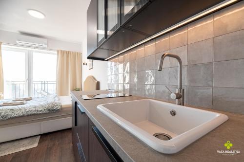 a kitchen with a large white sink in a kitchen at Castle Studio 7 Bojnice in Bojnice