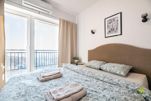 a bedroom with a large bed with two pillows on it at Castle Studio 7 Bojnice in Bojnice