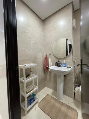a bathroom with a sink and a mirror at Appartement Moderne à Temara in Temara