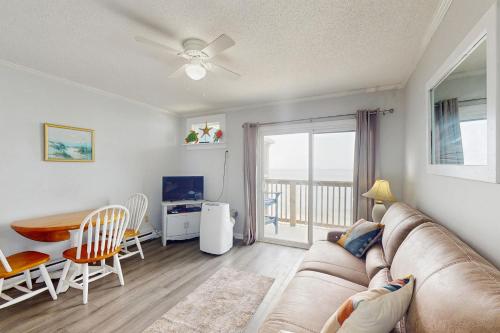 a living room with a couch and a table at NTBTR329 Totally Topsail in North Topsail Beach