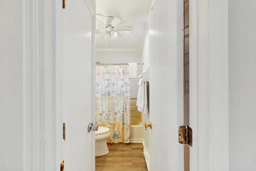 a bathroom with a toilet and a ceiling fan at NTBTR329 Totally Topsail in North Topsail Beach