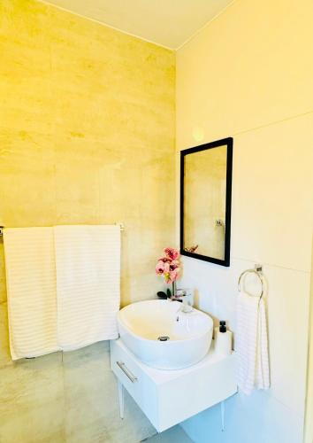 a bathroom with a white sink and a mirror at 12th on The Bay Apartment in Richards Bay