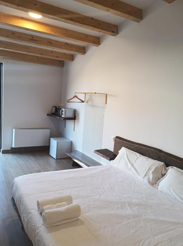 a bedroom with a bed with two towels on it at Pensión A Lubre in Fisterra