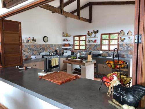 a kitchen with a counter top and a stove at Sueño Verde EcoVilla in Cerro Verde