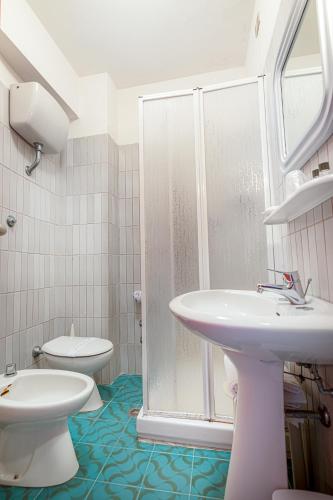 a bathroom with a toilet and a sink and a shower at Hotel Vittoria in Porto Santo Stefano