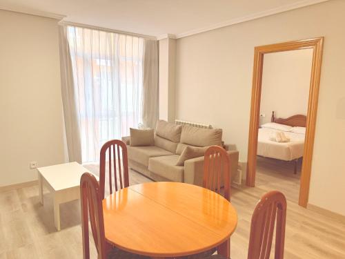 a living room with a table and a couch at Caballeros 7 in Soria
