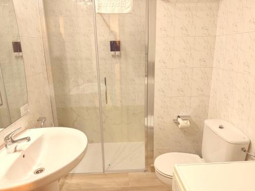 a bathroom with a shower and a sink and a toilet at Caballeros 7 in Soria