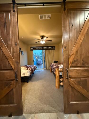 a room with two beds and a sliding barn door at Yosemite's Inn the Woods in Ahwahnee