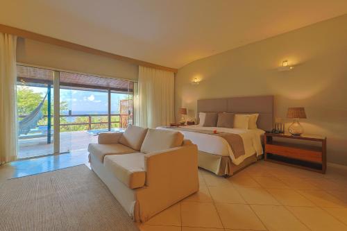 a large bedroom with a bed and a couch at Pousada Zé Maria in Fernando de Noronha