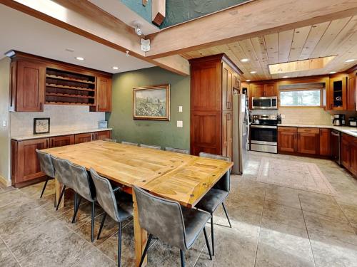 a large kitchen with a wooden table and chairs at Shoreline Chateau in Swanton