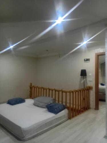 a bed in a room with lights on the ceiling at Edebiyat Apartments in Istanbul