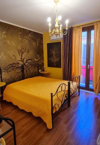 a bedroom with a bed and a chandelier at B&B AeR in Lesina