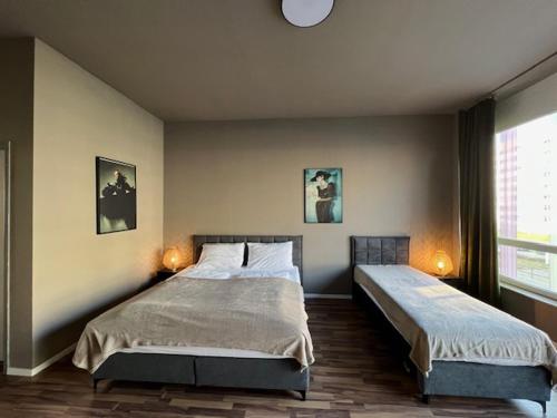 a bedroom with two beds and a window at N8 Rooms by BW Living in Leipzig