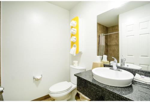 a bathroom with a white toilet and a sink at Studio 6 Extended Stay - Augusta, GA - Fort Gordon in Augusta