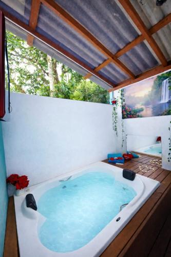 a jacuzzi tub on a deck with a window at Residencial Rodrigues Florianópolis in Florianópolis