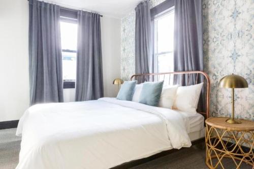 a bedroom with a white bed and a window at Inn at Gough in San Francisco