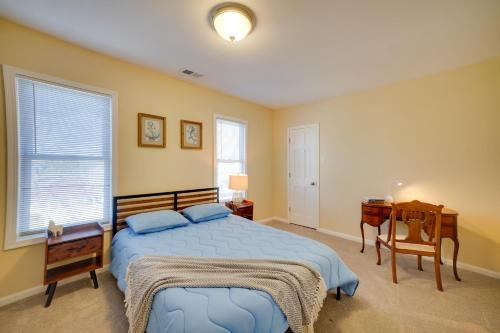 a bedroom with a bed and a desk and a window at Walk to Kinnickinnic Ave! Newly Updated Abode in Milwaukee