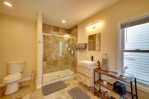 a bathroom with a shower and a toilet and a sink at Walk to Kinnickinnic Ave! Newly Updated Abode in Milwaukee