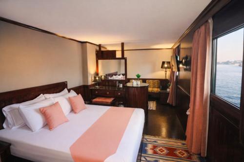 a bedroom with a bed with a view of the water at YOU Nile View Hotel in Cairo