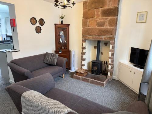 a living room with a couch and a fireplace at 18 Main Street in St Bees