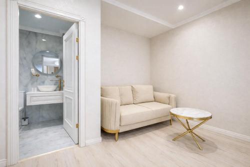 a living room with a chair and a sink at Yerevan In Boutique Hotel in Yerevan